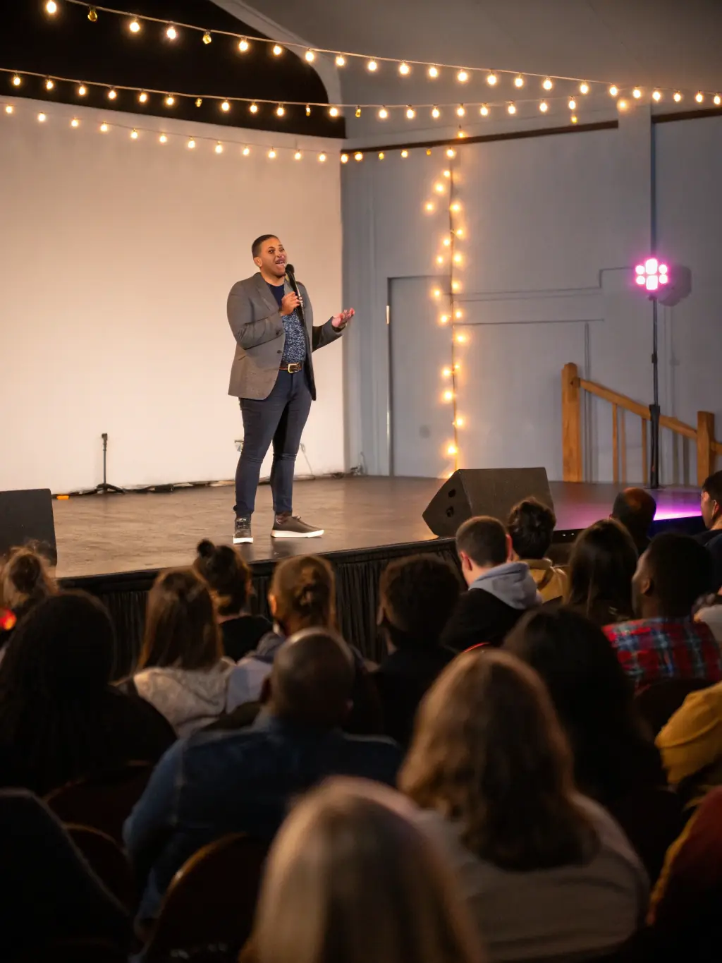 A person confidently presenting in front of an audience, representing public speaking and professional development.